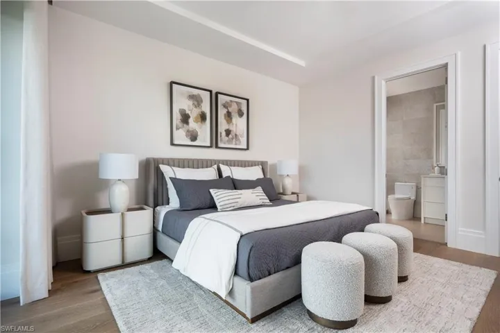 Bedroom featuring wood finished floors and connected bathroom