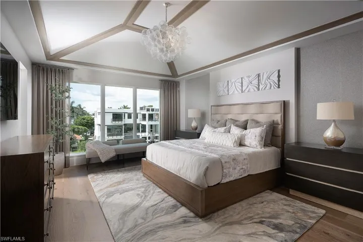Bedroom with a chandelier and wood finished floors