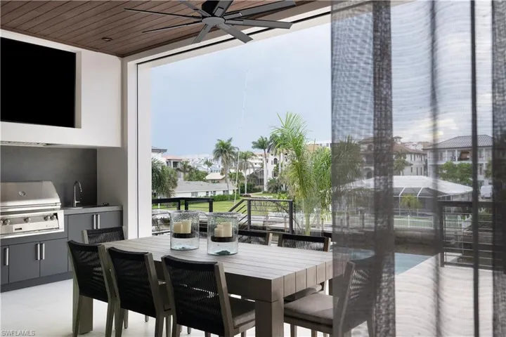 Dining area featuring a ceiling fan, healthy amount of natural light, and wooden ceiling