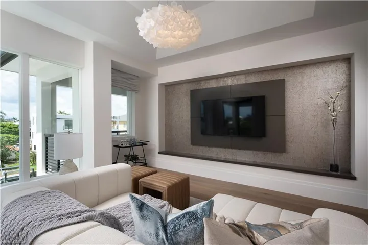Living area with wood finished floors and a chandelier