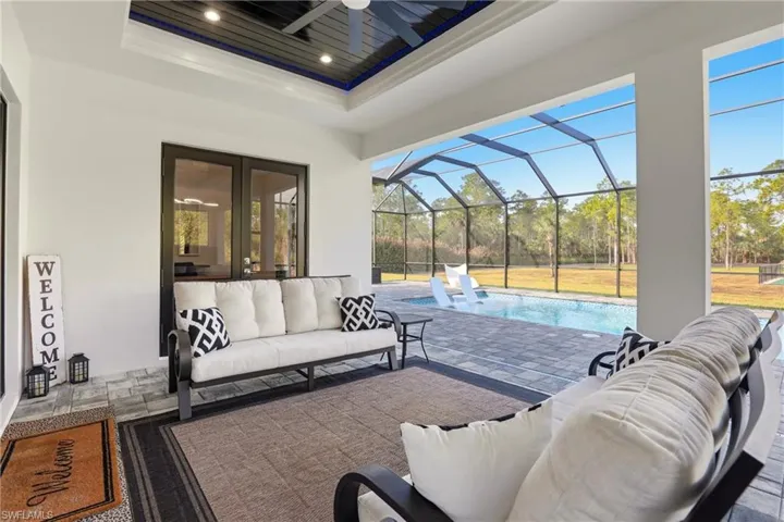 View of patio featuring an outdoor living space, a sunroom, an outdoor pool, a lanai, and ceiling fan