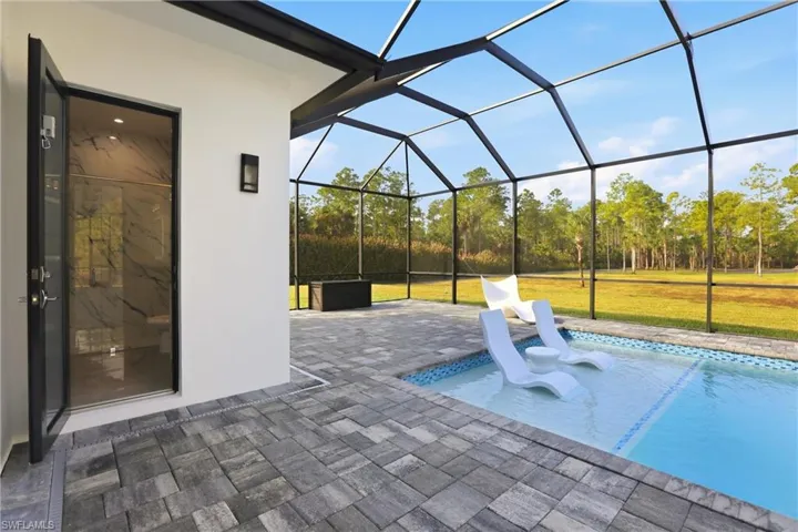 View of patio with a sunroom, a lanai, and an outdoor pool