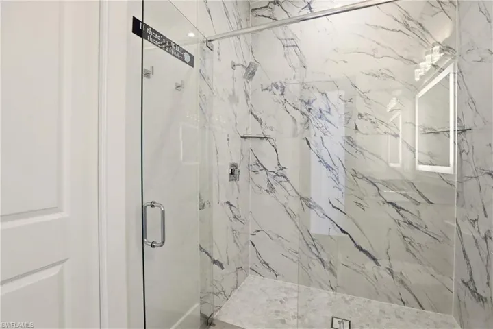 Bathroom with a marble finish shower