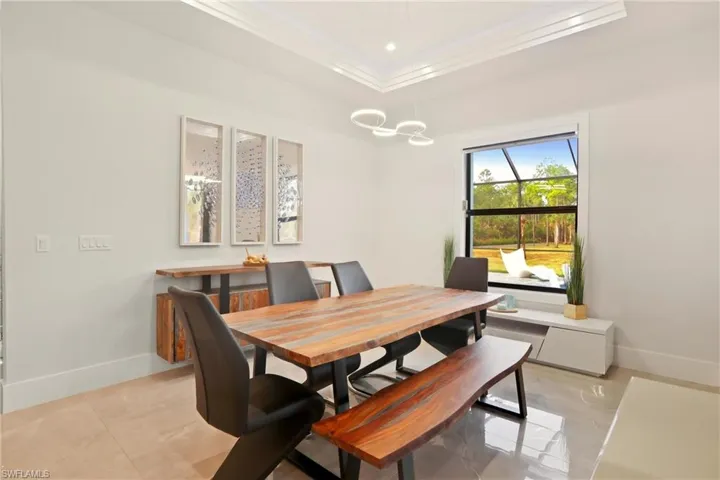 Dining area featuring baseboards and crown molding
