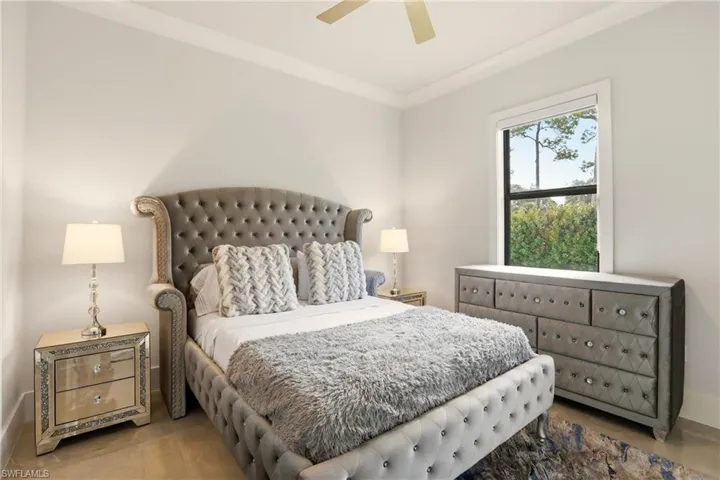 Bedroom with crown molding and a ceiling fan