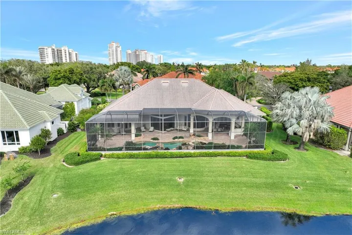 Aerial view of the back of the home and its lush backyard.