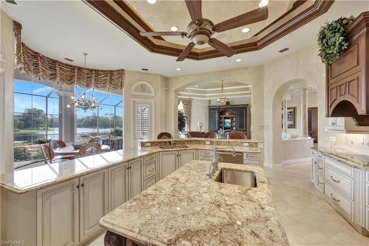 Chat with guests in the great room as you're preparing a meal in this stunning kitchen with marble countertops and designer cabinetry.