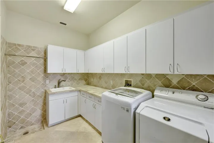 This spacious laundry room makes doing laundry easy plus there's lots of storage.