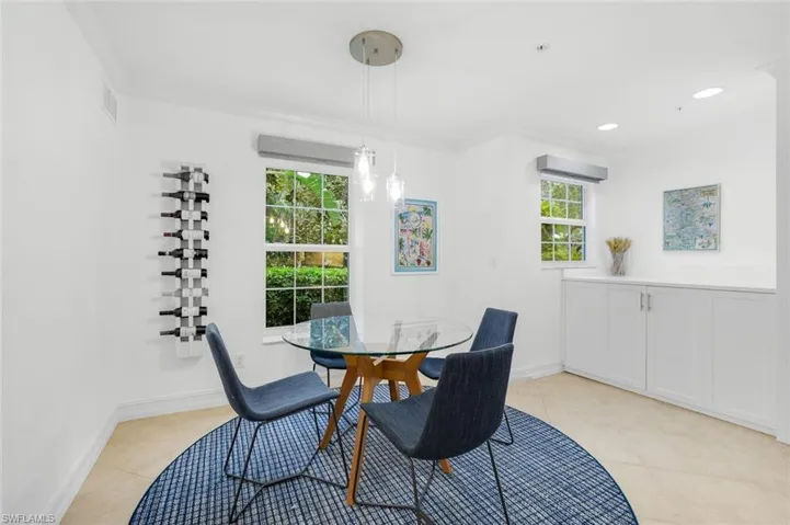 Dining space featuring light tile patterned flooring and recessed lighting