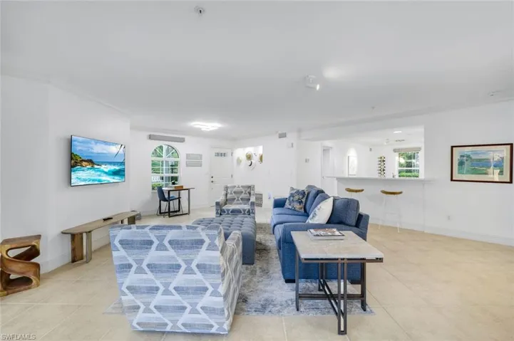 Living room featuring light tile patterned floors and baseboards