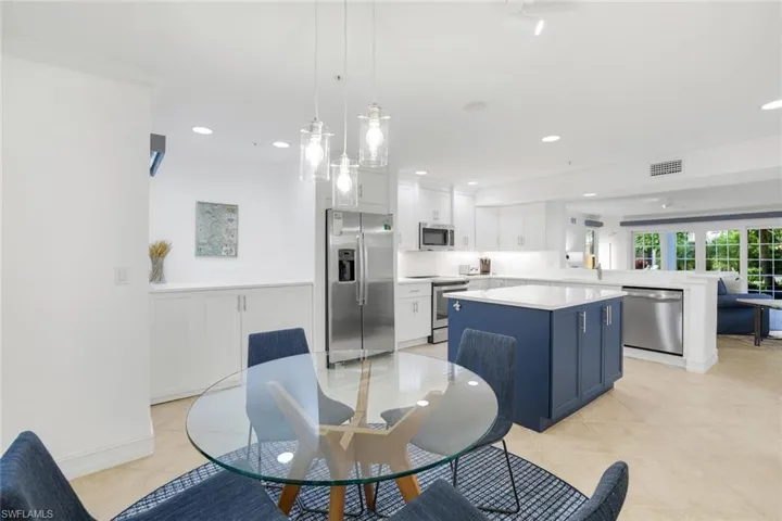 Dining room with recessed lighting and light tile patterned floors