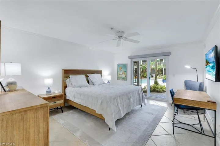 Bedroom featuring crown molding, access to exterior, and ceiling fan
