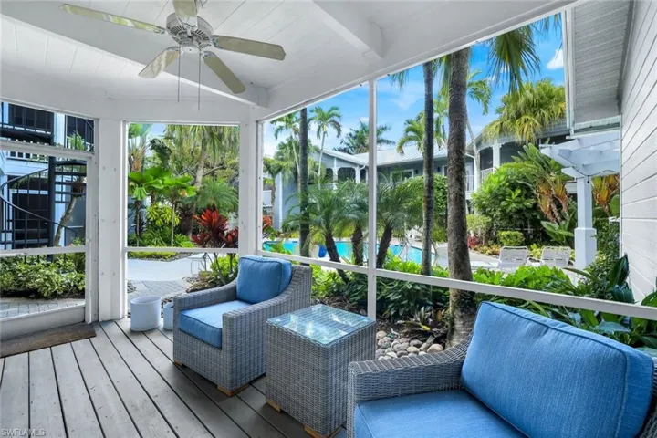 Sunroom featuring a ceiling fan and a deck
