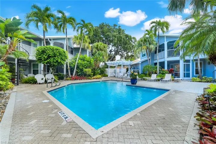 Community pool featuring a patio area, a balcony, a sunroom, and a pergola