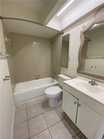 Full bathroom featuring vanity, shower / tub combination, and light tile patterned floors
