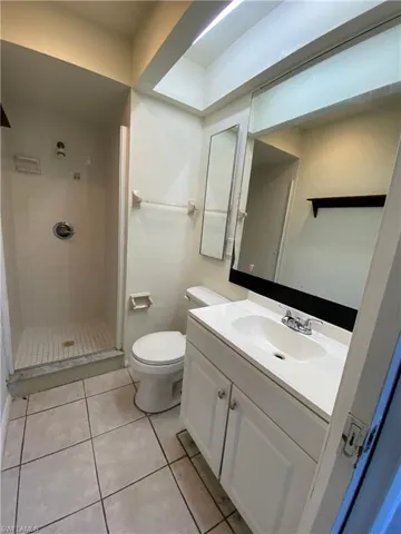 Bathroom featuring vanity, a stall shower, and light tile patterned floors