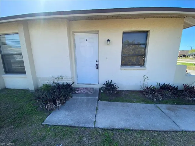 Doorway to property with stucco siding