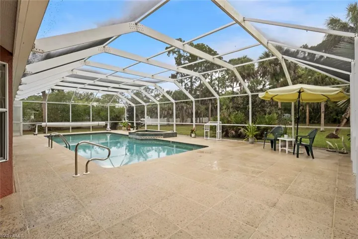 Screened lanai, features a beautiful travertine tile.  Screens have been replaced.