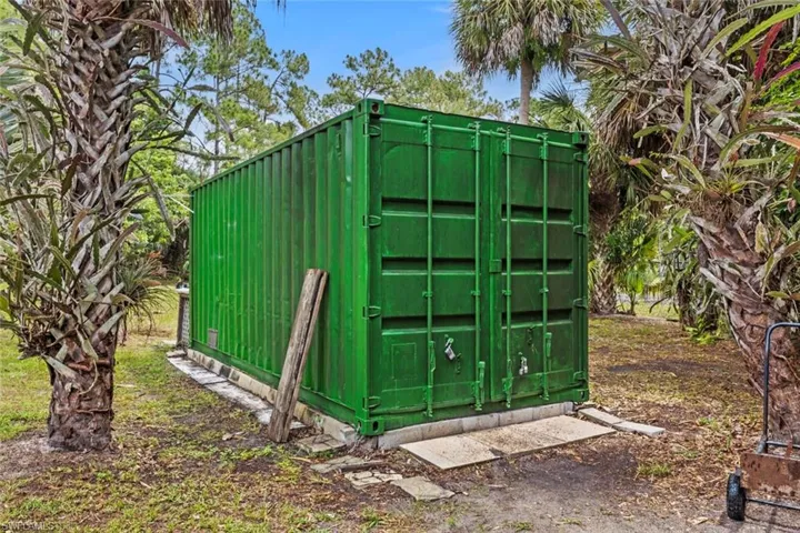 20 foot permitted  metal storage container. is on the right side of property has shelves and overhead storage as well, perfect onsite storage.