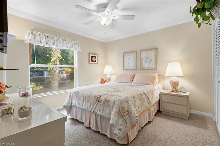 Carpeted bedroom with a window featuring exterior landscaping