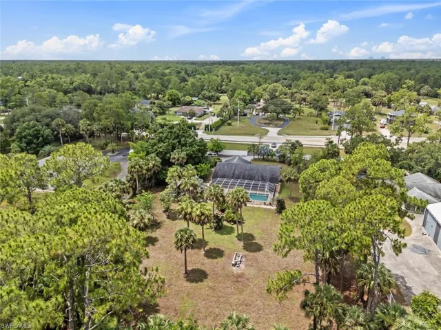 Expansive property with a single-story residence featuring a screened-in swimming pool