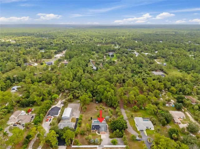 Aerial view of home on oversized 2.73 acre lot with an expansive natural landscape