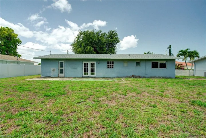 Back of house featuring french doors, stucco siding, and a patio area