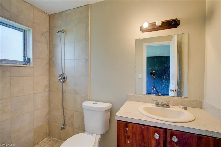 Full bath with vanity and a tile shower