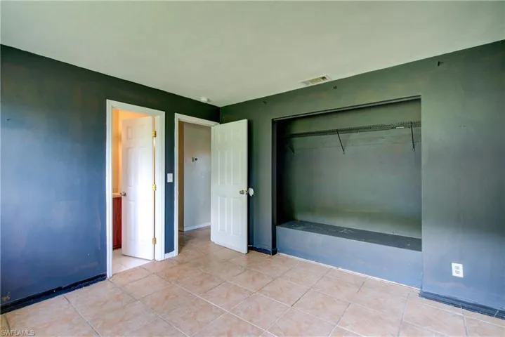 Unfurnished bedroom featuring a closet and light tile patterned floors