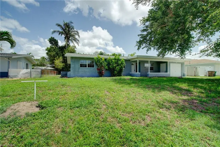 Back of property featuring an attached garage