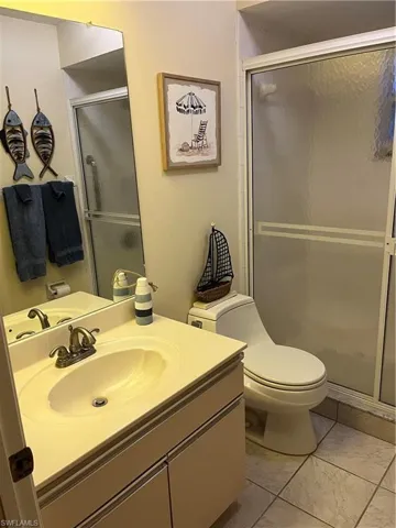 Bathroom featuring a single vanity with integrated sink, bronze-finish faucet, and coordinating cabinetry