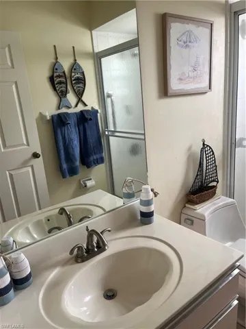 Built-in vanity with integrated sink and brushed nickel faucet