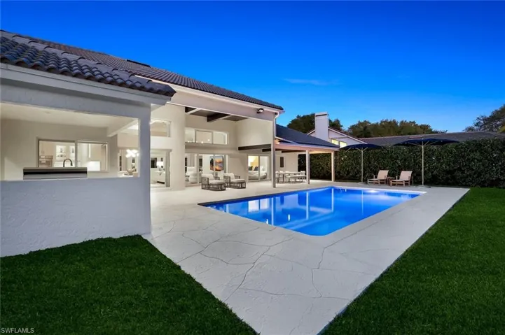 View of swimming pool featuring patio surround, a yard, and an outdoor hangout area