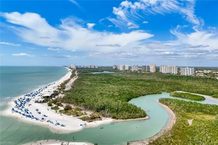 View of home's community featuring view of water and beach and a city view