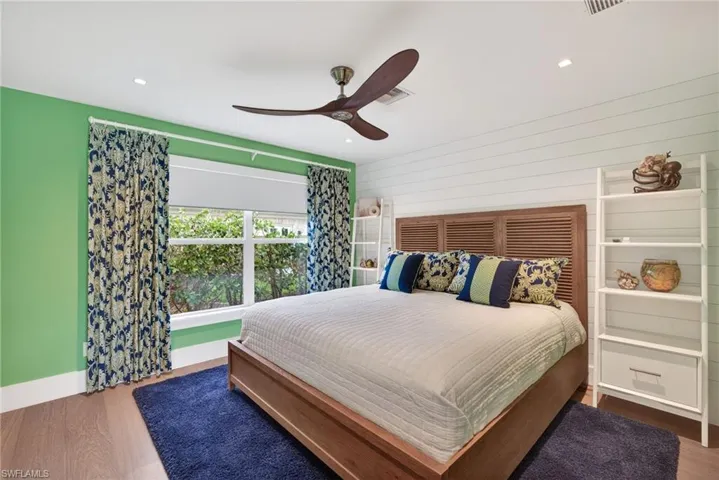 Bedroom featuring wood finished floors, ceiling fan, and recessed lighting