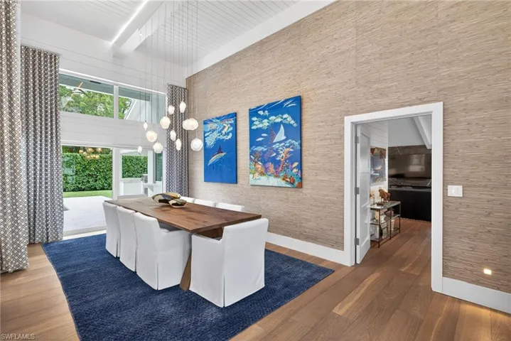 Dining area featuring dark wood-style flooring and baseboards