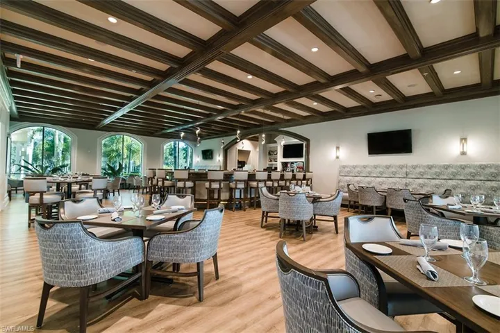 Dining area featuring beamed ceiling and light wood-type flooring
