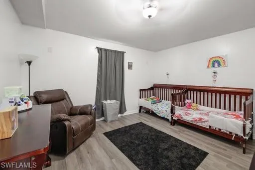 Bedroom featuring wood-type flooring
