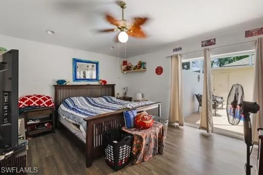 Bedroom with dark hardwood / wood-style floors and ceiling fan