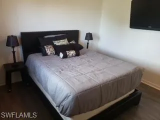 Bedroom featuring dark wood-type flooring