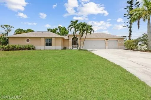 View of front of home featuring a garage and a front lawn