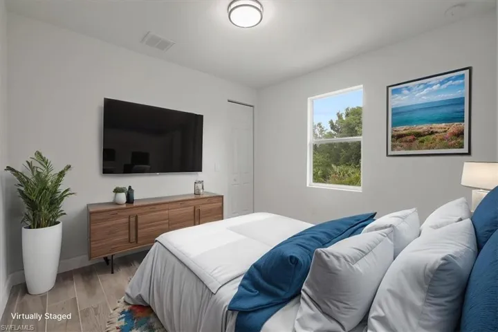 Bedroom with light wood finished floors and baseboards