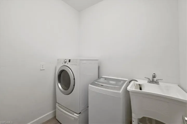 Laundry room featuring separate washer and dryer and baseboards