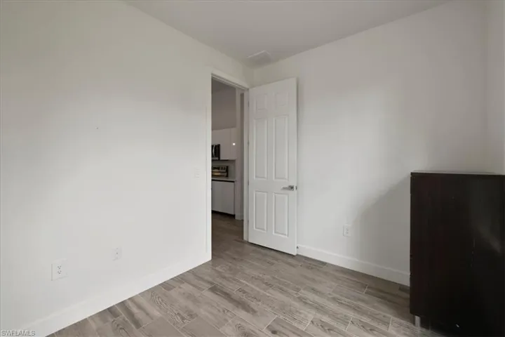 Spare room with light wood-style flooring and baseboards