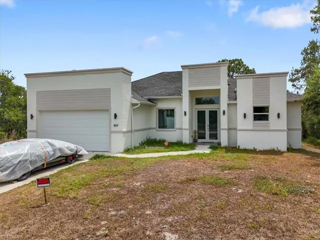Modern home featuring french doors, stucco siding, a garage, roof with shingles, and driveway