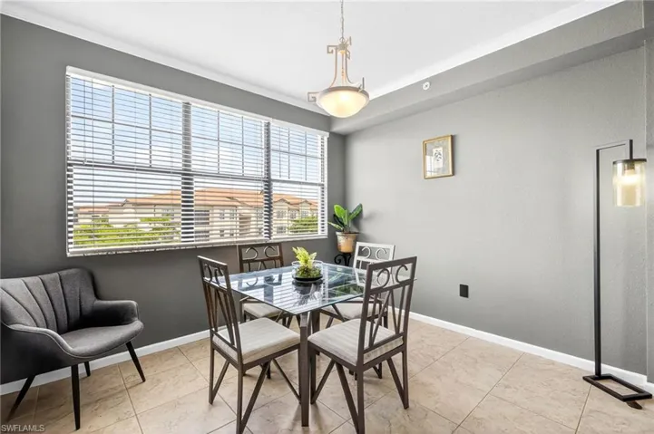 Dining space featuring crown molding and baseboards