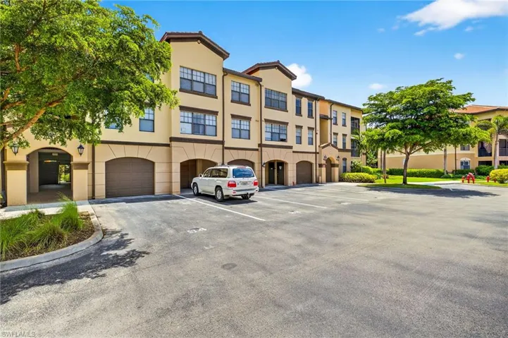 View of apartment building / complex featuring an attached garage