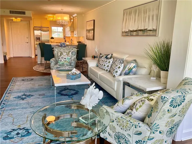 Living room featuring an inviting chandelier and wood-type flooring