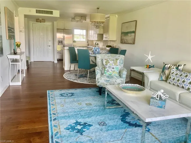 Living room with dark wood-type flooring and sink