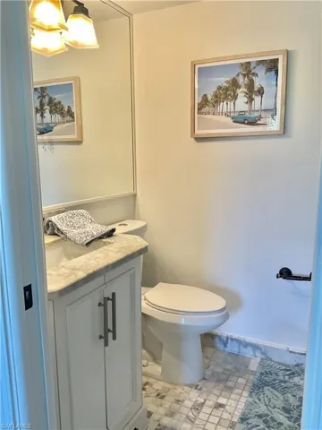 Bathroom with vanity, tile patterned flooring, and toilet